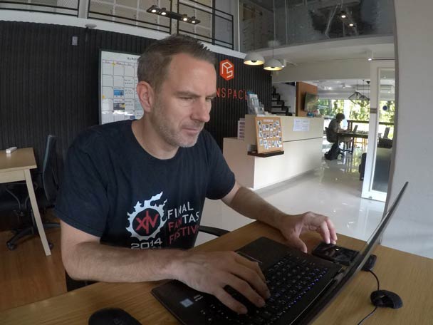 Marc working from a laptop on location.